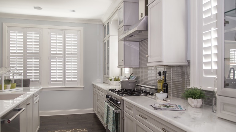 Plantation shutters in San Diego kitchen with white cabinets.